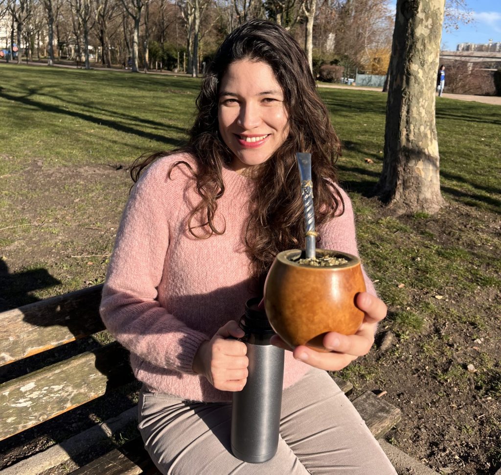 Mujer sosteniendo un mate de calabaza listo para ser degustado